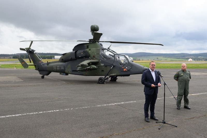 German Minister of Defense Boris Pistorius (L) gives a press statement in front of a Tiger combat helicopter during his visit to Helicopter Regiment 36 to get an idea of the capabilities of the soldiers and civilian staff. Swen Pförtner/dpa