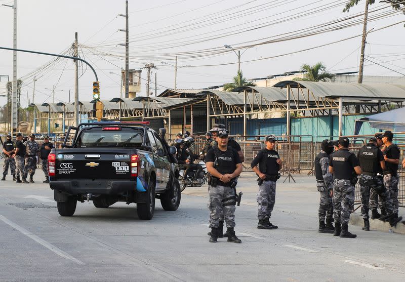 Police stand guard during a prison riot in Guayaquil