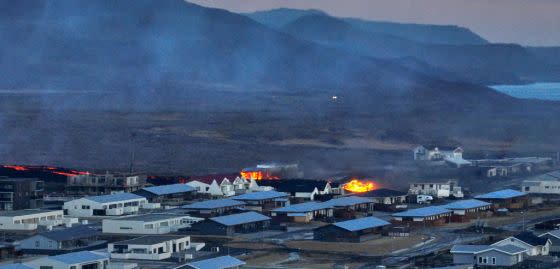 Grindavík: Lava explosions and smoke can be seen near residential buildings in the Icelandic town, after a second fissure opened around midday, local time.<span class="copyright">HALLDOR KOLBEINS/AFP—Getty Images)</span>