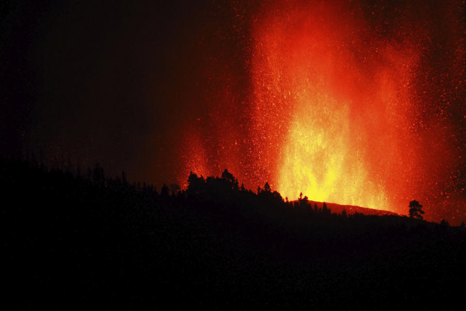 Lava flows from an eruption of a volcano near El Paso on the island of La Palma in the Canaries, Spain, Sunday, Sept. 19, 2021. Lava continues to flow slowly from a volcano that erupted in Spain’s Canary Islands off northwest Africa. The head of the islands' regional government says Monday he expects no injuries to people in the area after some 5,000 were evacuated. (Europa Press via AP)