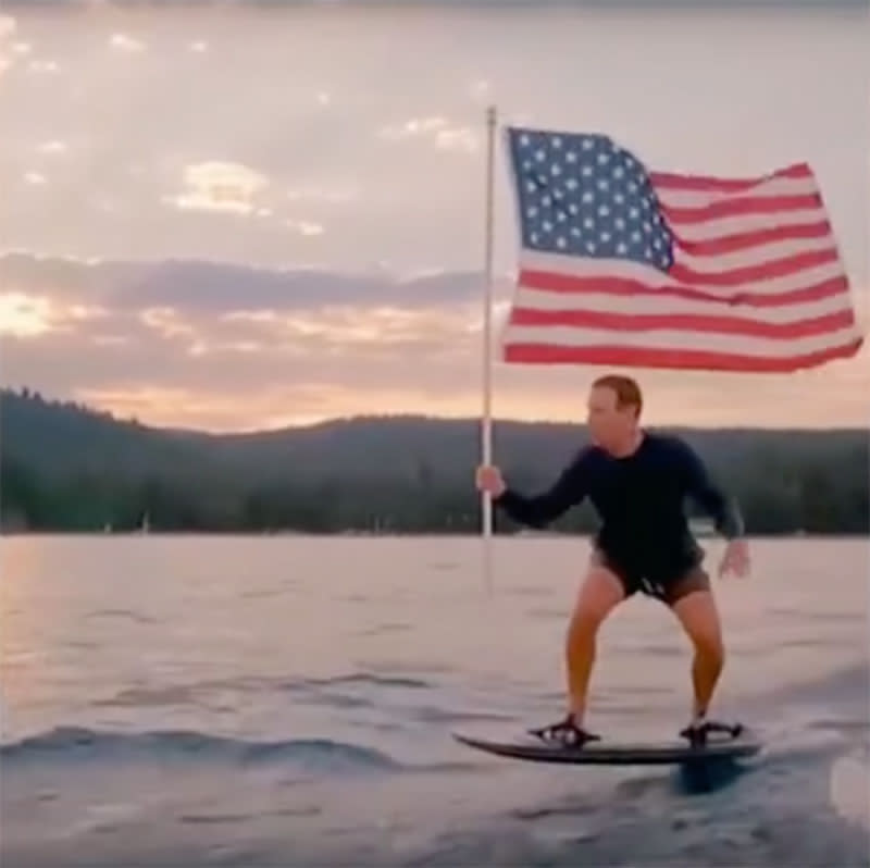 Mark Zuckerberg rides a hydro-foil board while waving an American flag in a 4th July video