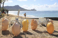 Watercraft vehicles sit on Waikiki Beach waiting to be rented Thursday, Oct. 15, 2020, in Honolulu. A new pre-travel testing program will allow visitors who test negative for COVID-19 to come to Hawaii and avoid two weeks of mandatory quarantine goes into effect Thursday. The pandemic has caused a devastating downturn on Hawaii's tourism-based economy and many are hoping the testing will help the economy rebound. (AP Photo/Marco Garcia)