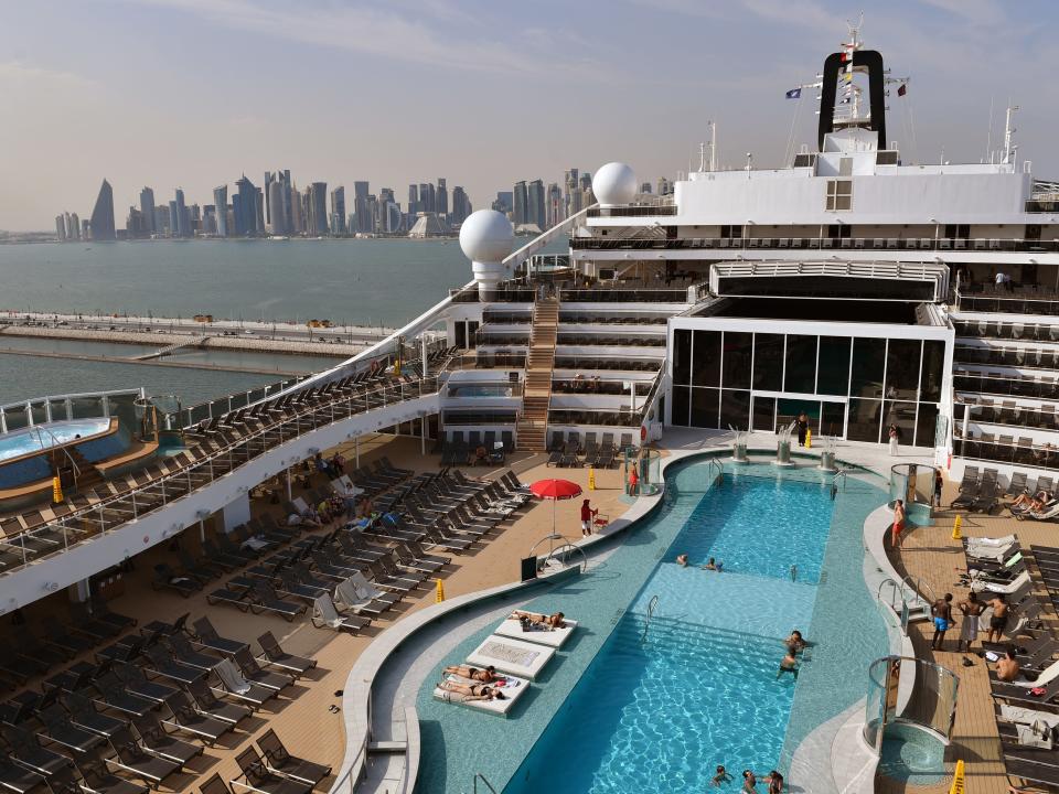 Guests relax beside the pool on board MSC World Europa on November 12, 2022 in Doha, Qatar.