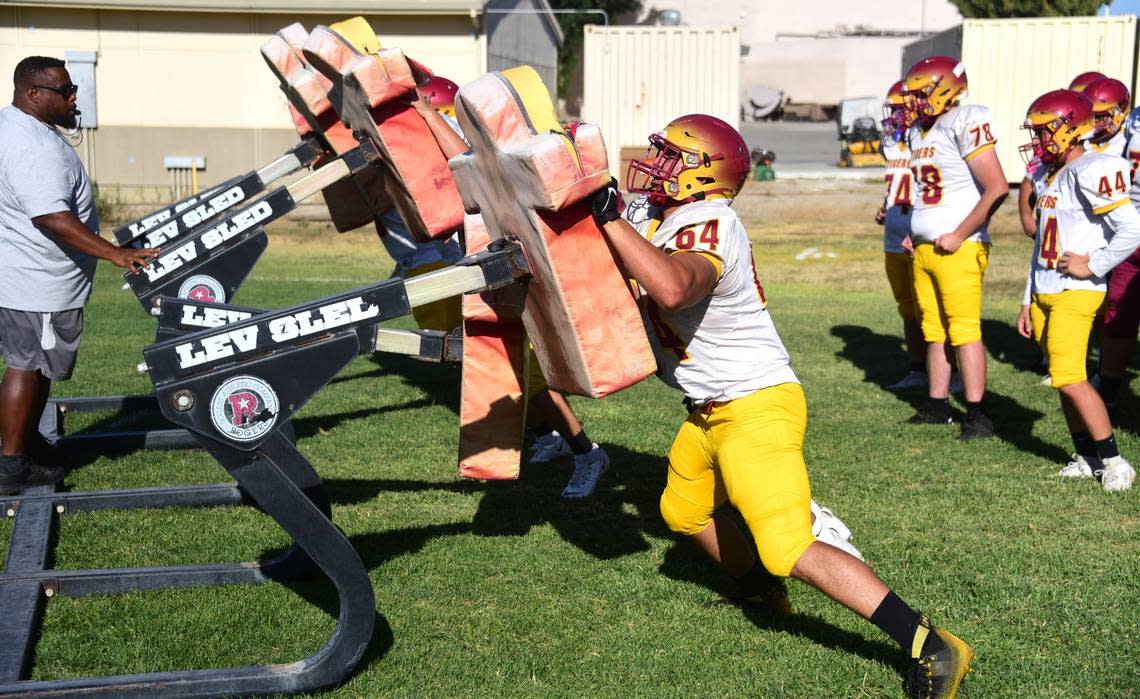 Los Banos High School linemen go through drills at practice on Tuesday, Aug. 13, 2024.