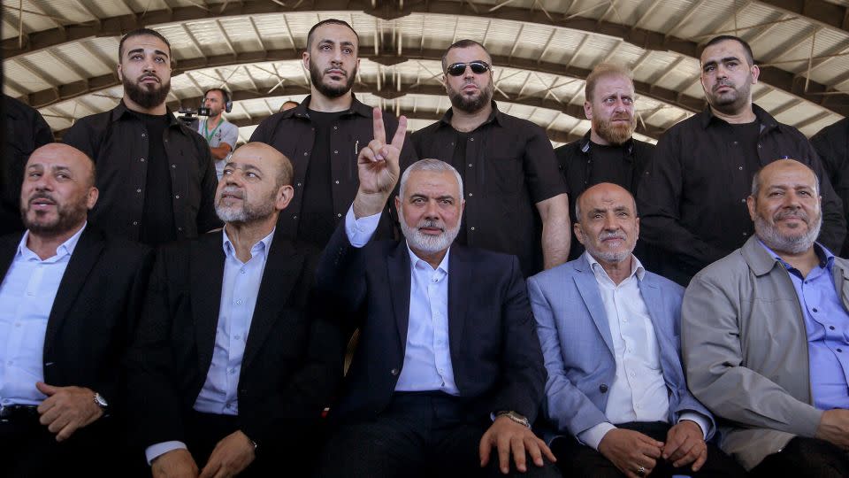 Ismail Haniyeh, center, chairman of the Hamas political bureau, flashes a victory sign, flanked by bodyguards and senior Palestinian officials during a rally at the southern Lebanese port city of Sidon. - Marwan Naamani/picture alliance/Getty Images