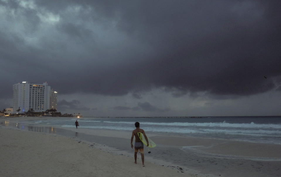 Clouds gather over Playa Gaviota Azul as Tropical Storm Zeta approaches Cancun, Mexico, early Monday morning, Oct. 26, 2020. A strengthening Tropical Storm Zeta is expected to become a hurricane Monday as it heads toward the eastern end of Mexico's resort-dotted Yucatan Peninsula and then likely move on for a possible landfall on the central U.S. Gulf Coast at midweek. (AP Photo/Victor Ruiz Garcia)