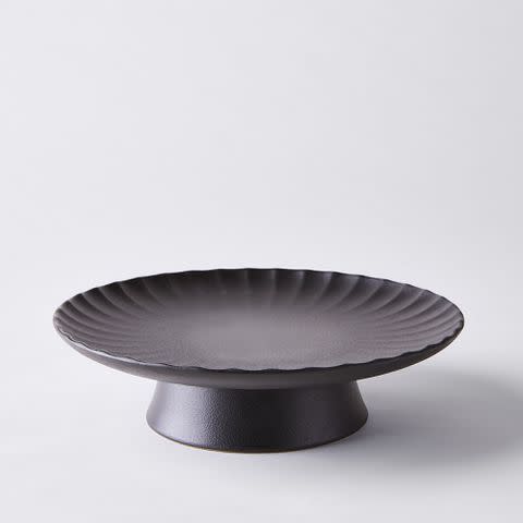 black ceramic cake stand with scalloped edges