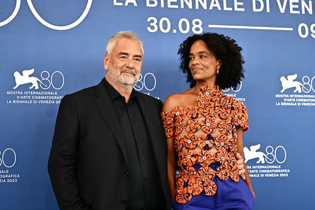 <p>GABRIEL BOUYS/AFP via Getty</p> French director and producer Luc Besson and his wife Virginie Besson-Silla pose during the photocall of the movie "Dogman" presented in competion at the 80th Venice Film Festivalon August 31, 2023 at Venice Lido.