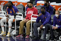 Phoenix Suns guard Devin Booker watches from the bench during the first half of an NBA basketball game against the Oklahoma City Thunder, Wednesday, Jan. 27, 2021, in Phoenix. (AP Photo/Matt York)