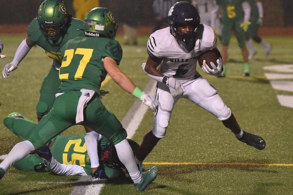 Millbrook’s Xavier Pugh (6) runs for the touchdown against Cardinal Gibbons’ Nolan Wirick (27) in the second half. The Cardinal Gibbons Crusaders and the Millbrook Wildcats met in a NCHSAA 4A playoff game in Raleigh, NC on November 10, 2022