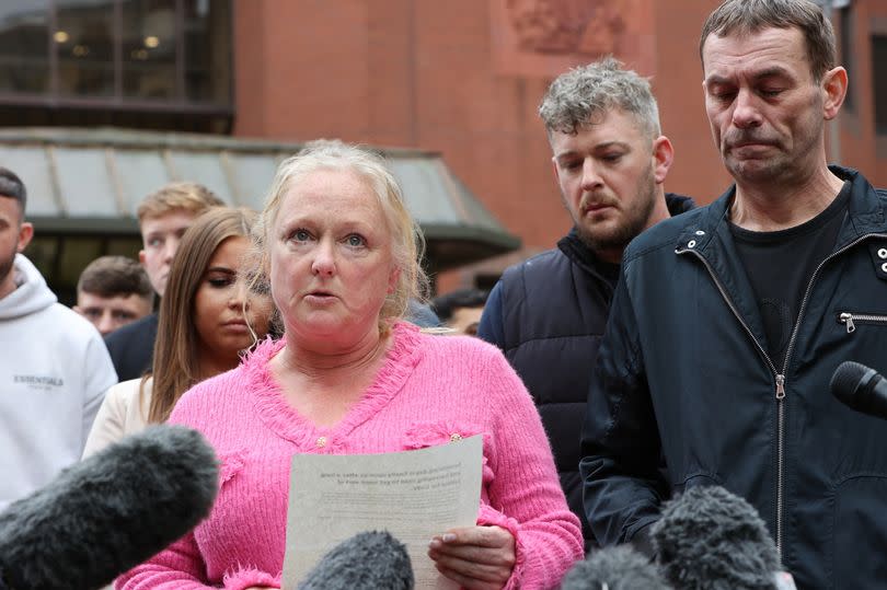 Cody Fisher's parents Tracey Fisher (pink) and Chris Fisher (far right)