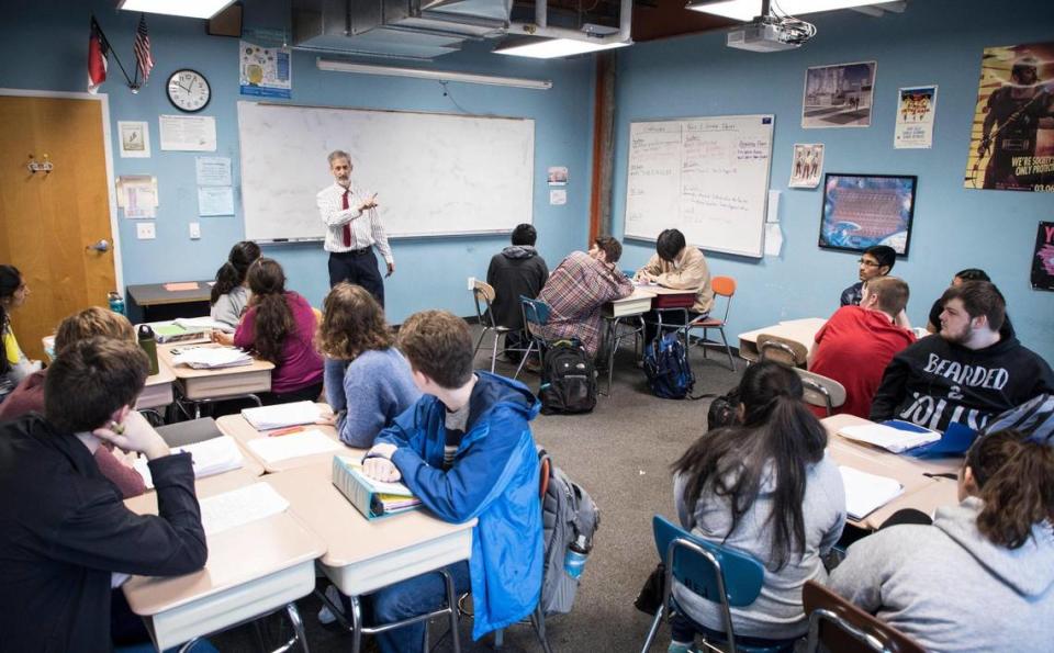 Kenny Felder, a math teacher at Raleigh Charter High School, explains repeating decimals to calculus students in February 2019.