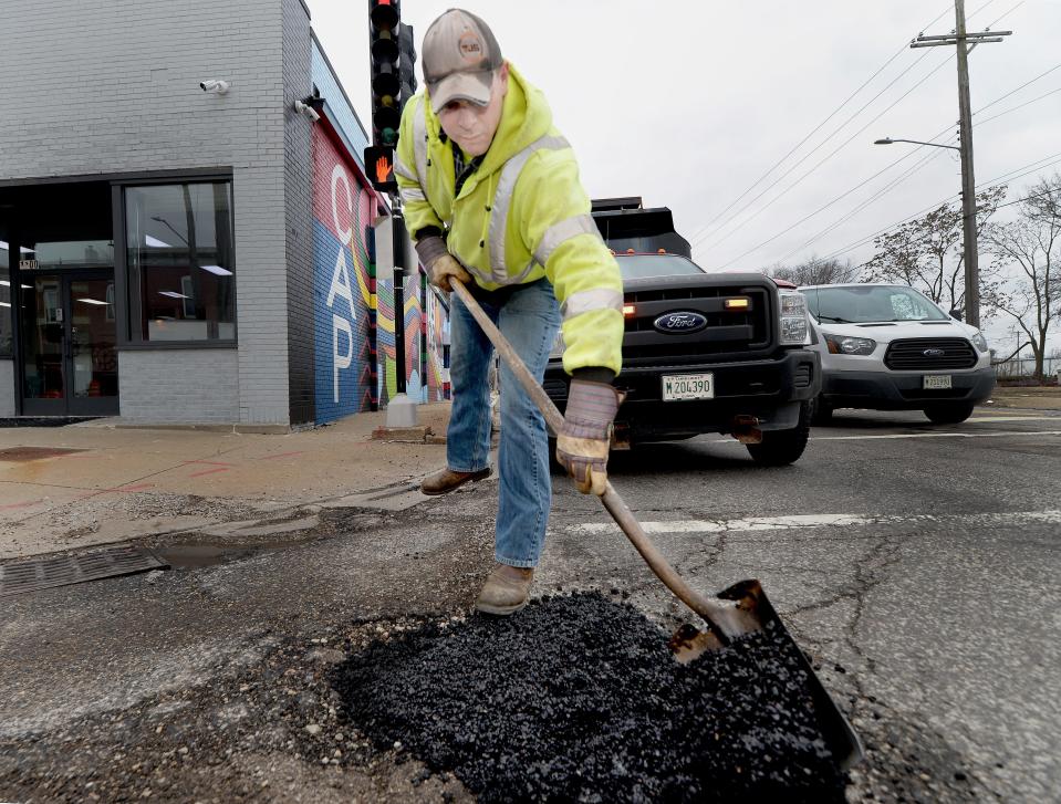 City of Springfield Public Works employee Kevin Brandenburg fills a pothole on the corner of South Grand Avenue and 11th Street Tuesday, January 30, 2024.