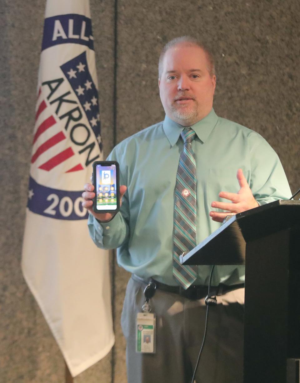 City of Akron Chief Technology Manager Darren Rozenek explains the new snowplow tracker application Wednesday during a news conference at the Ocasek Building auditorium.