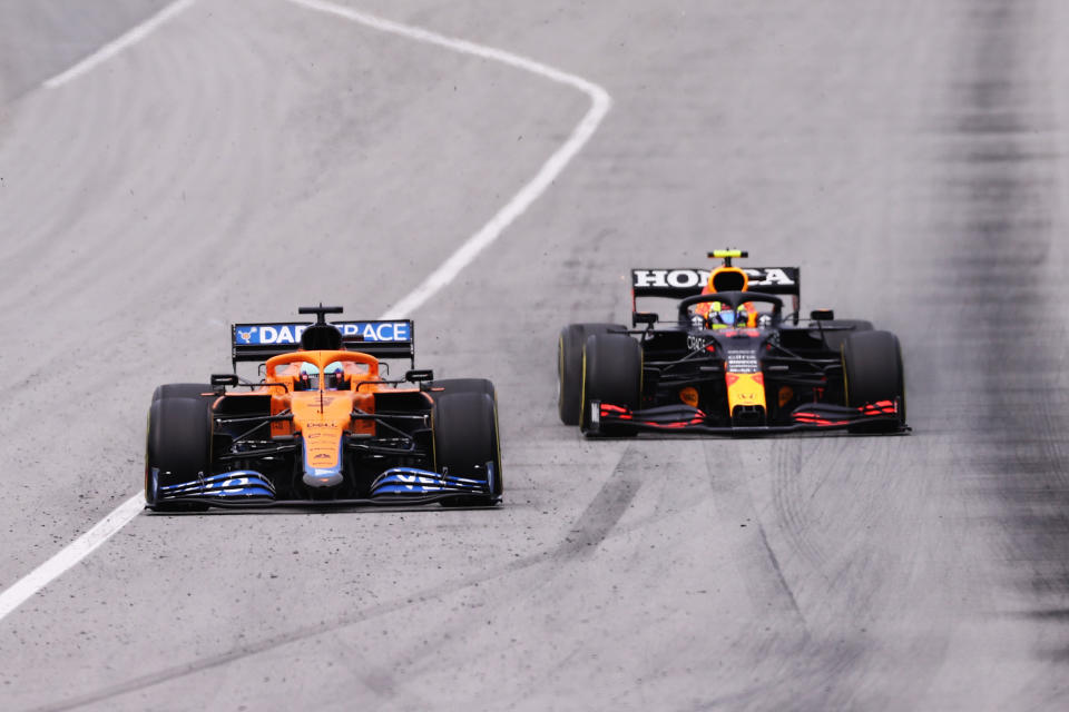 BARCELONA, SPAIN - MAY 09: Daniel Ricciardo of Australia driving the (3) McLaren F1 Team MCL35M Mercedes and Sergio Perez of Mexico driving the (11) Red Bull Racing RB16B Honda on track during the F1 Grand Prix of Spain at Circuit de Barcelona-Catalunya on May 09, 2021 in Barcelona, Spain. (Photo by Lars Baron/Getty Images)