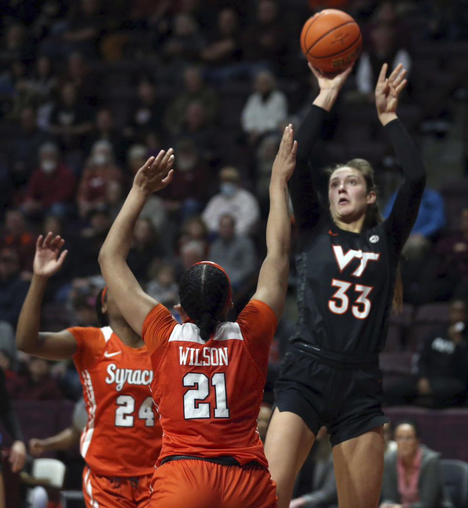 Virginia Tech's Elizabeth Kitley (33) shoots over Syracuse's Saniaa Wilson (21) during the first half of an NCAA college basketball game in Blacksburg, Va., Thursday, Feb. 2, 2023. (Matt Gentry/The Roanoke Times via AP)