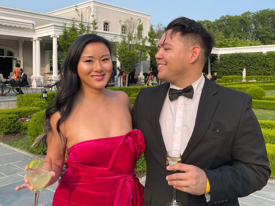 Waverly Colville and her boyfriend, John, dressed up and holding cocktails.