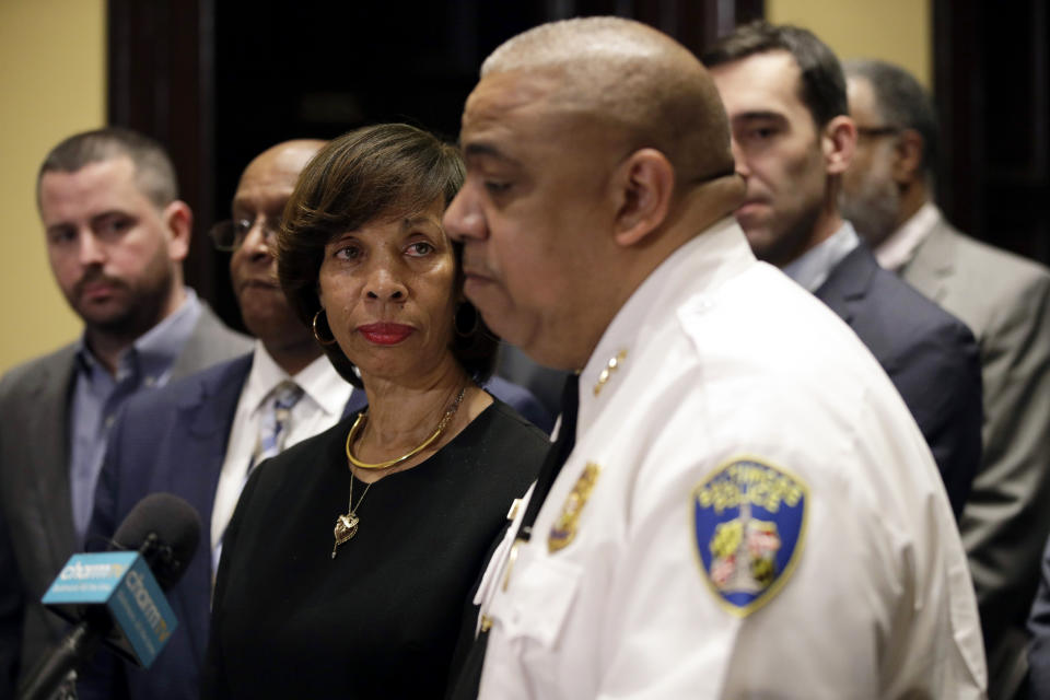 Baltimore Mayor Catherine Pugh, left, listens as Michael Harrison, acting commissioner of the Baltimore Police Department, speaks at an introductory news conference, Monday, Feb. 11, 2019, in Baltimore. Harrison, the former Superintendent of the New Orleans Police Department, started Monday as acting leader weeks before the city council is expected to vote on his nomination as permanent police commissioner. (AP Photo/Patrick Semansky)