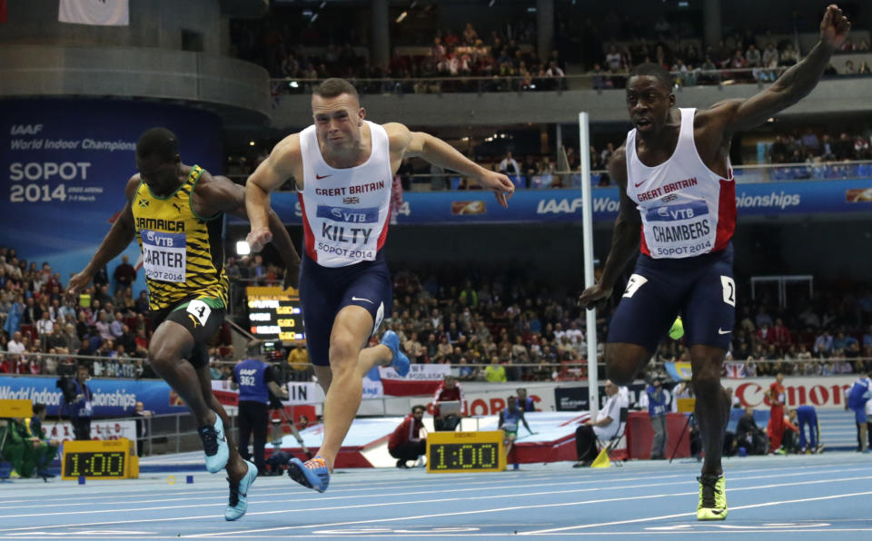 Jamaica's Nesta Carter, Britain's gold medal winner Richard Kilty and Britain's Dwain Chambers, from left, cross the line of the men's 60m final during the Athletics Indoor World Championships in Sopot, Poland, Saturday, March 8, 2014. (AP Photo/Matt Dunham)