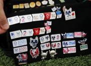 Yoshiyuki Terajima, a pin collector based in Tokyo, shows his Olympic pin collection near the National Stadium in Tokyo