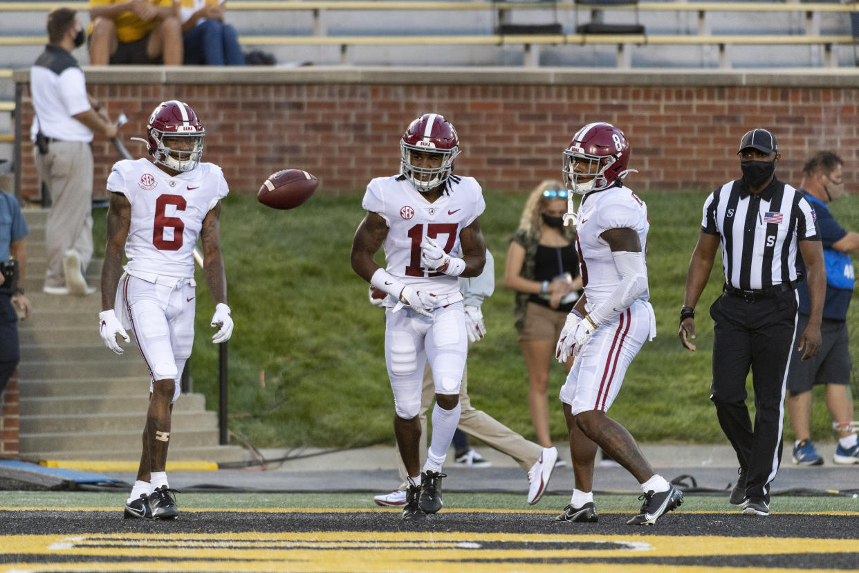 Alabama wide receiver Jaylen Waddle, center, celebrates with teammates DeVonta Smith, left, and John Metchie III, right, after scoring a TD against Missouri on Sept. 26. (AP)