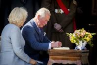 <p>Prince Charles and Camilla sign the guest book at Castle Coole after a garden party.</p>