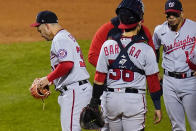 Washington Nationals starting pitcher Paolo Espino, left, leaves during the first inning in the second baseball game of the team's doubleheader against the New York Mets, Tuesday, Oct. 4, 2022, in New York. (AP Photo/Frank Franklin II)