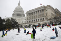 <p>Families sled down a hill on the House side of the Capitol in Washington, Wednesday, March 21, 2018, during a spring snowstorm. (Photo: Jacquelyn Martin/AP) </p>