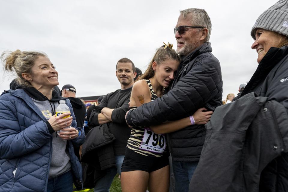 Penn High School senior Mary Eubank is greeted by her supporters after finishing the 43rd annual IHSAA Girls Cross Country State Championship, Saturday, Oct. 28, 2023, at LaVern Gibson Championship Cross County Course.