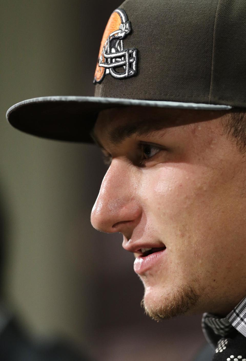 Cleveland Browns quarterback Johnny Manziel, from Texas A&M, answers questions at his introductory news conference at the NFL football team's facility in Berea, Ohio Friday, May 9, 2014. The Browns selected Manziel 22nd overall in the first round in Thursday's NFL draft, after taking Oklahoma State cornerback Justin Gilbert with the eighth pick. (AP Photo/Mark Duncan)