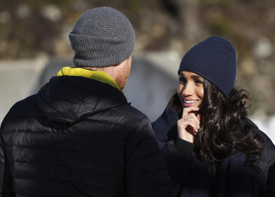 Prince Harry and Meghan Markle, the Duke and Duchess of Sussex, walk together after Harry slid down the track on a skeleton sled while attending an Invictus Games training camp, in Whistler, British Columbia, Thursday, Feb. 15, 2024. Invictus Games Vancouver Whistler 2025 is scheduled to take place from Feb. 8 to 16, 2025 and will for the first time feature winter sports. (Darryl Dyck/The Canadian Press via AP)
