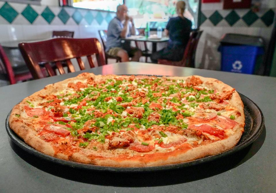 A BBQ chicken pizza is freshly pulled from an oven at Fellini Pizzeria on Wickenden Street in Providence.