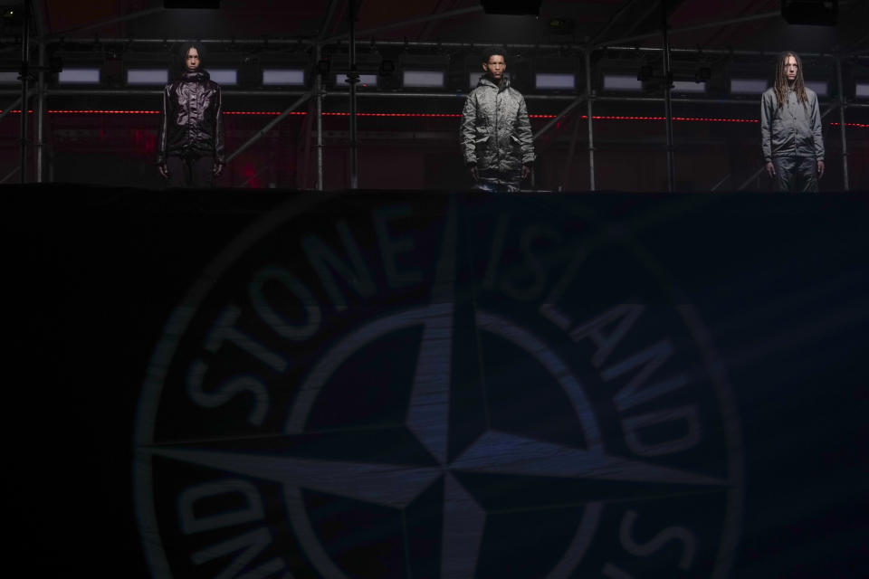 Models wear creations as part of the men's Stone Island Fall-Winter 2024-2025 collection, that was presented in Milan, Italy, Friday, Jan. 12, 2024. (AP Photo/Luca Bruno).
