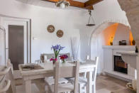 <p>The home’s eating area is picturesque, with the table in front of a modernized fireplace.<br>(Airbnb) </p>