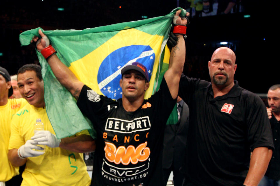 RIO DE JANEIRO, BRAZIL - JANUARY 14: Referee Dan Miragliotta (R) holds up Vitor Belfort (C) after defeating Anthony Johnson (not pictured) in a middleweight bout during UFC 142 at HSBC Arena on January 14, 2012 in Rio de Janeiro, Brazil. (Photo by Josh Hedges/Zuffa LLC/Zuffa LLC via Getty Images)