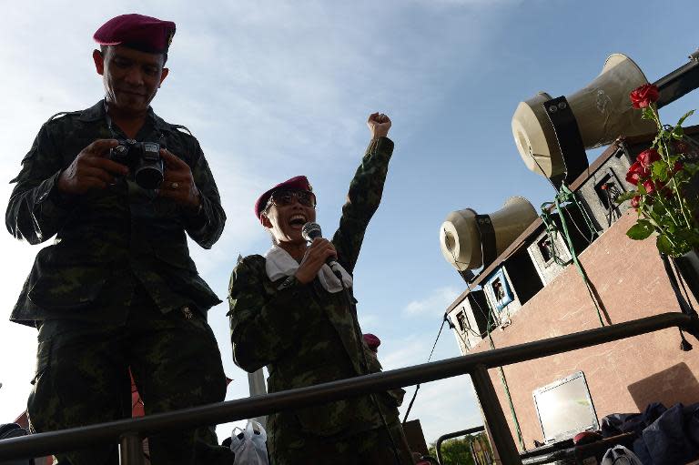 A soldier sings at a military event organised to 'return happiness to the people' at Victory Monument, the site of recent anti-coup rallies in Bangkok, on June 4, 2014