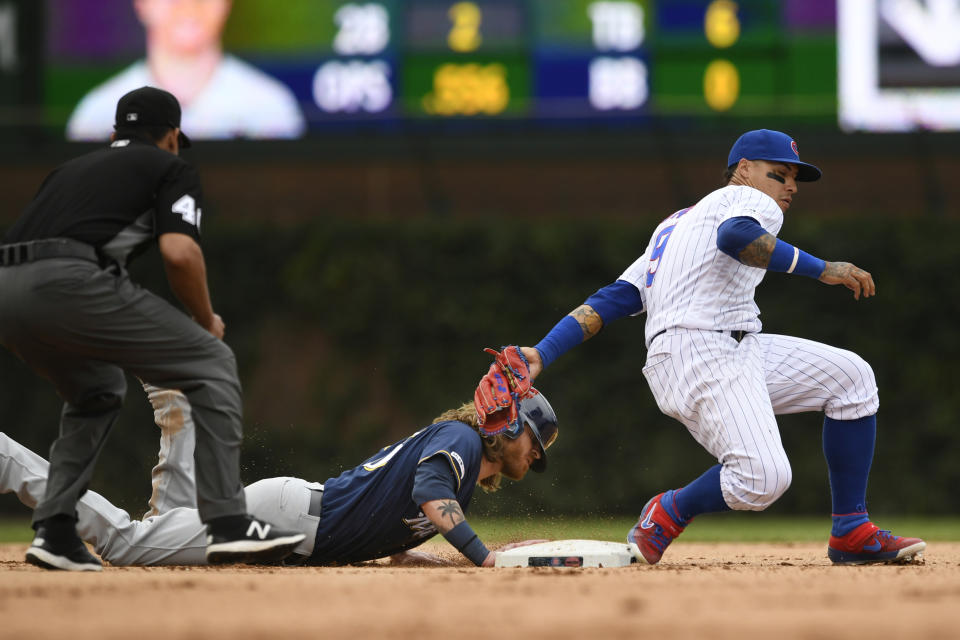 Milwaukee Brewers' Ben Gamel left, slides safely into second base as Chicago Cubs shortstop Javier Baez right, attempts to apply the tag during the ninth inning of a baseball game Saturday, Aug 31, 2019, in Chicago. Milwaukee won 2-0. (AP Photo/Paul Beaty)