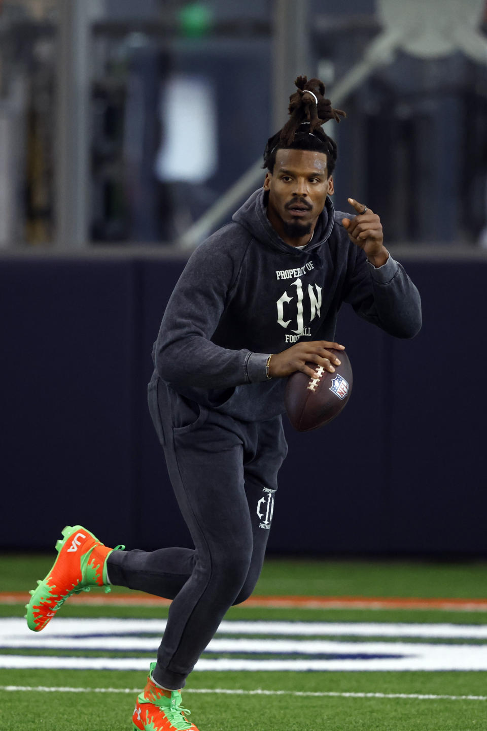 Former NFL and Auburn quarterback, Cam Newton, rolls out to pass during Auburn Pro Day, Tuesday, March 21, 2023, in Auburn, Ala. (AP Photo/Butch Dill)