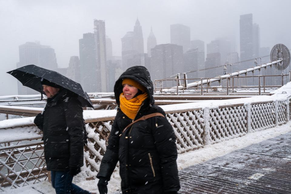 eople walk across the Brooklyn Bridge in the blowing snow in Manhattan as a large winter storm makes its way across the area on February 13, 2024 in New York City (Getty Images)