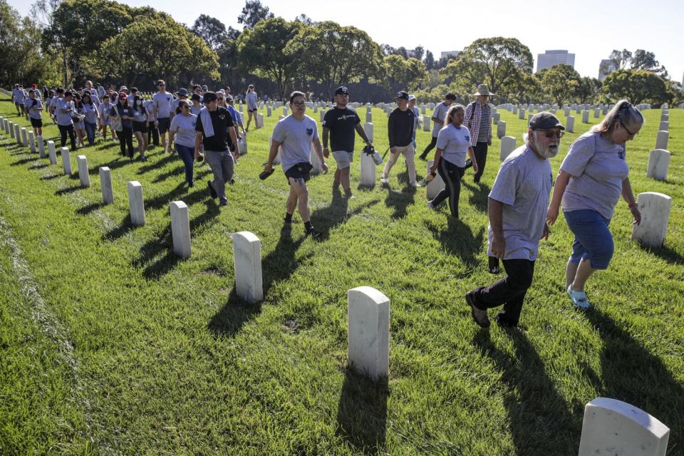 Volunteers in Los Angeles National Cemetery to clean veterans' headstones.