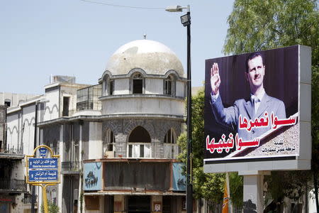 A billboard depicting Syria's President Bashar al-Assad is seen in the old city of Homs June 3, 2015. REUTERS/Omar Sanadiki