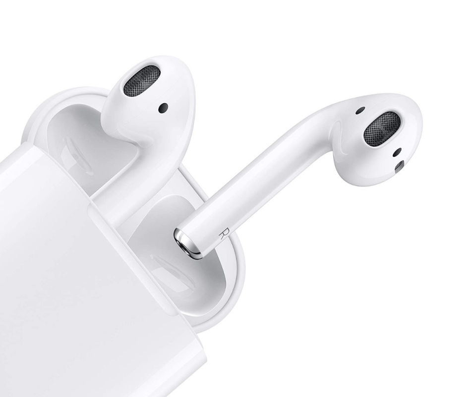 Apple AirPods half way out of the white charging case on a white background.