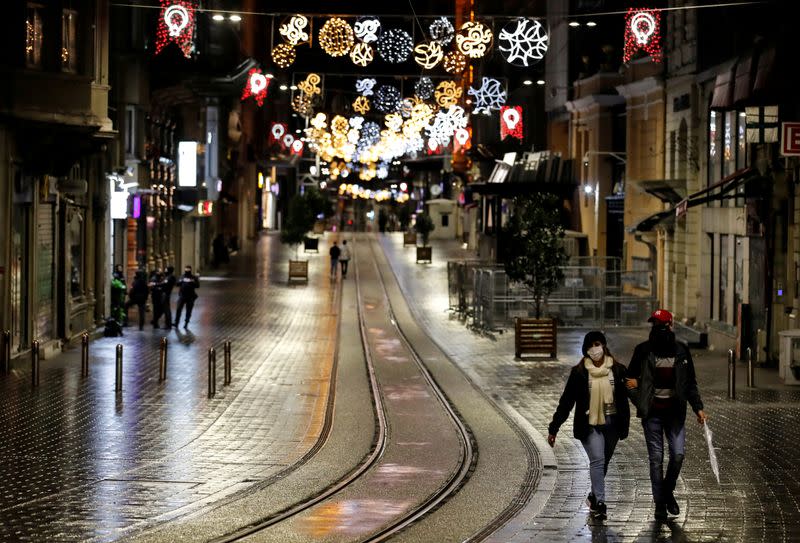 FILE PHOTO: Tourist couple walks along Istiklal Street in Istanbul