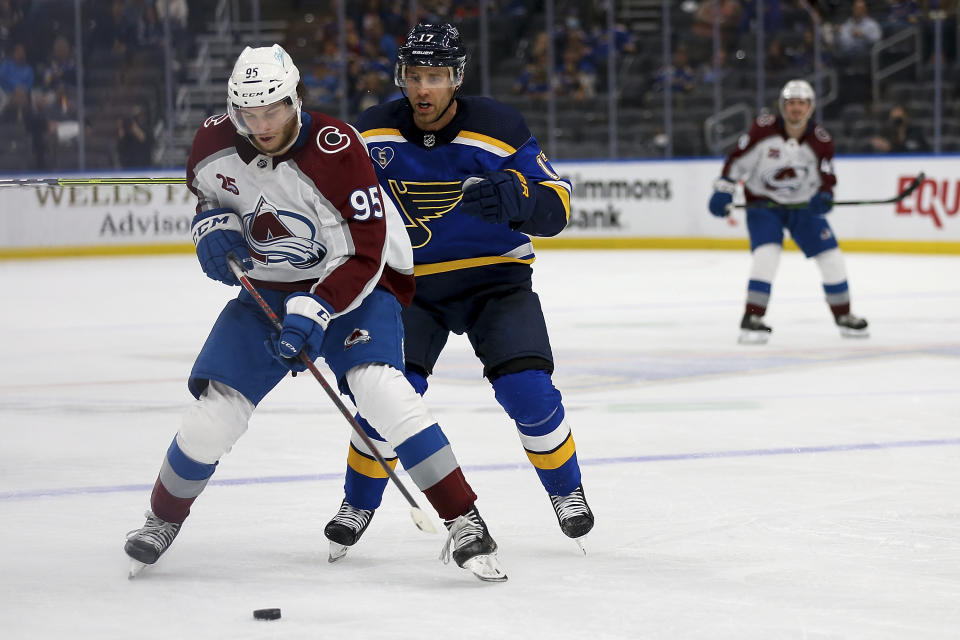 Colorado Avalanche's Andre Burakovsky (95) controls the puck in front of St. Louis Blues' Jaden Schwartz (17) during the third period in Game 3 of an NHL hockey Stanley Cup first-round playoff series Friday, May 21, 2021, in St. Louis. (AP Photo/Scott Kane)