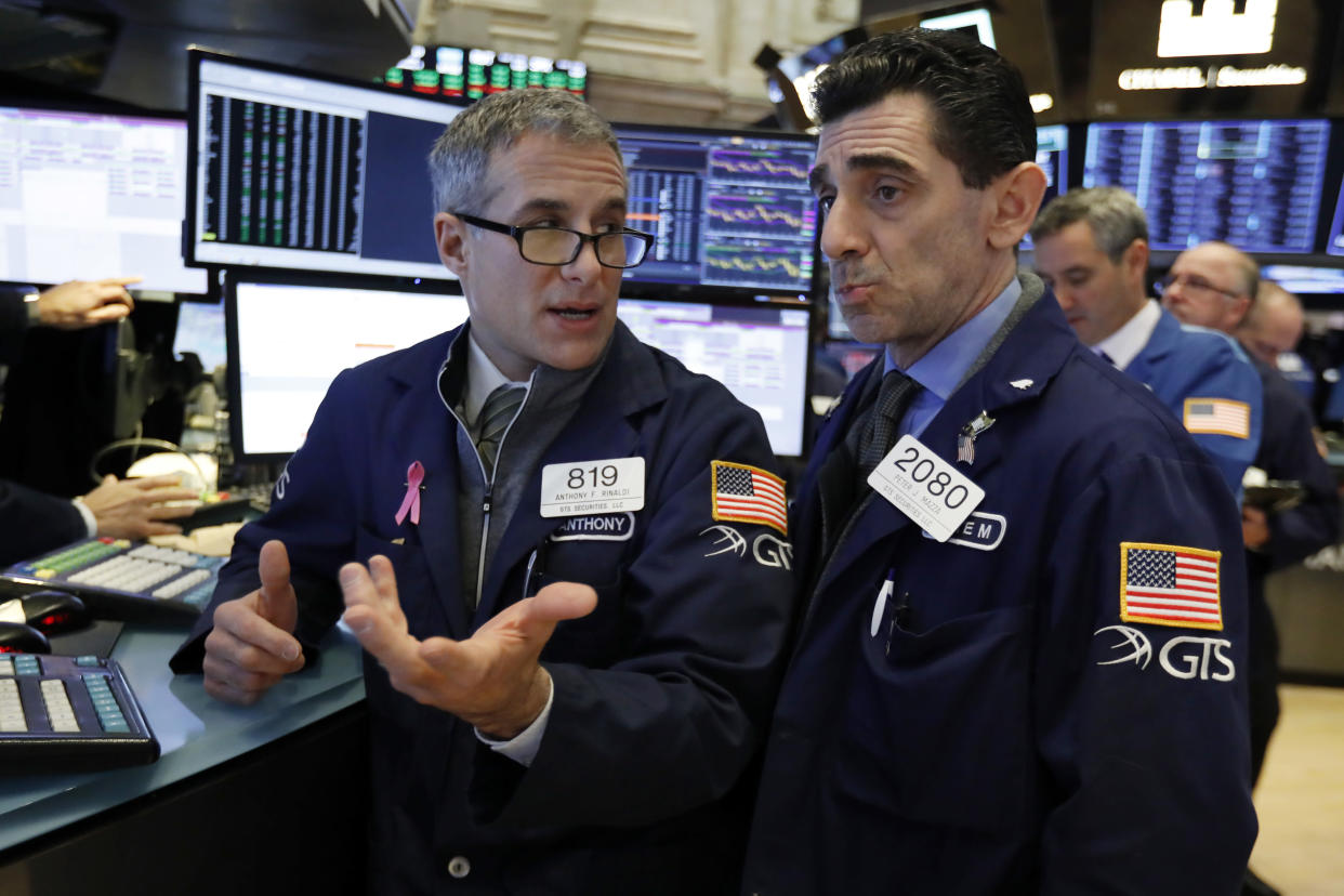Specialists Anthony Rinaldi, left, and Peter Mazza confer as they work on the floor of the New York Stock Exchange, Friday, Jan. 4, 2019. Stocks are jumping at the open on Wall Street Friday as investors welcome news of trade talks between the U.S. and China and a big gain in jobs in the U.S. (AP Photo/Richard Drew)