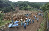 Police officers search for missing people at a landslide site caused by a heavy rain in Tsunagi town, Kumamoto prefecture, Japan