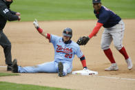 Minnesota Twins' Josh Donaldson calls for time after safely sliding into third base ahead of the tag of Boston Red Sox third baseman Rafael Devers (11) in the first inning in the second baseball game of a doubleheader, Wednesday, April 14, 2021, in Minneapolis. (AP Photo/Andy Clayton-King)