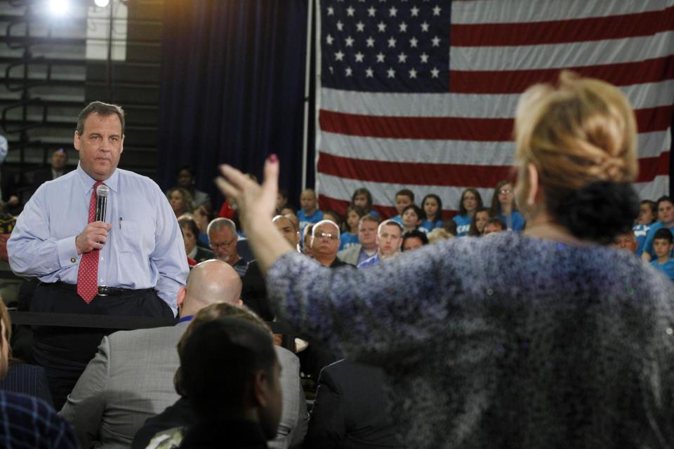 New Jersey Gov. Chris Christie listens to Carol Raab Davis of Toms River, during a town hall meeting in Brick Township, N.J., Thursday, April 24, 2014. Many questions at the town hall focused on the state's Sandy recovery efforts. (AP Photo/Mel Evans)