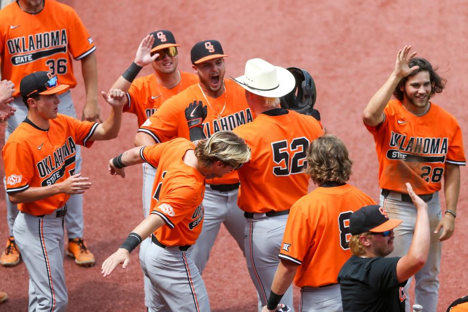OSU pitcher Victor Mederos, center, yells as infielder Griffin Doersching (52) celebrates with teammates after hitting a grand slam to take the lead against Missouri State on Sunday.