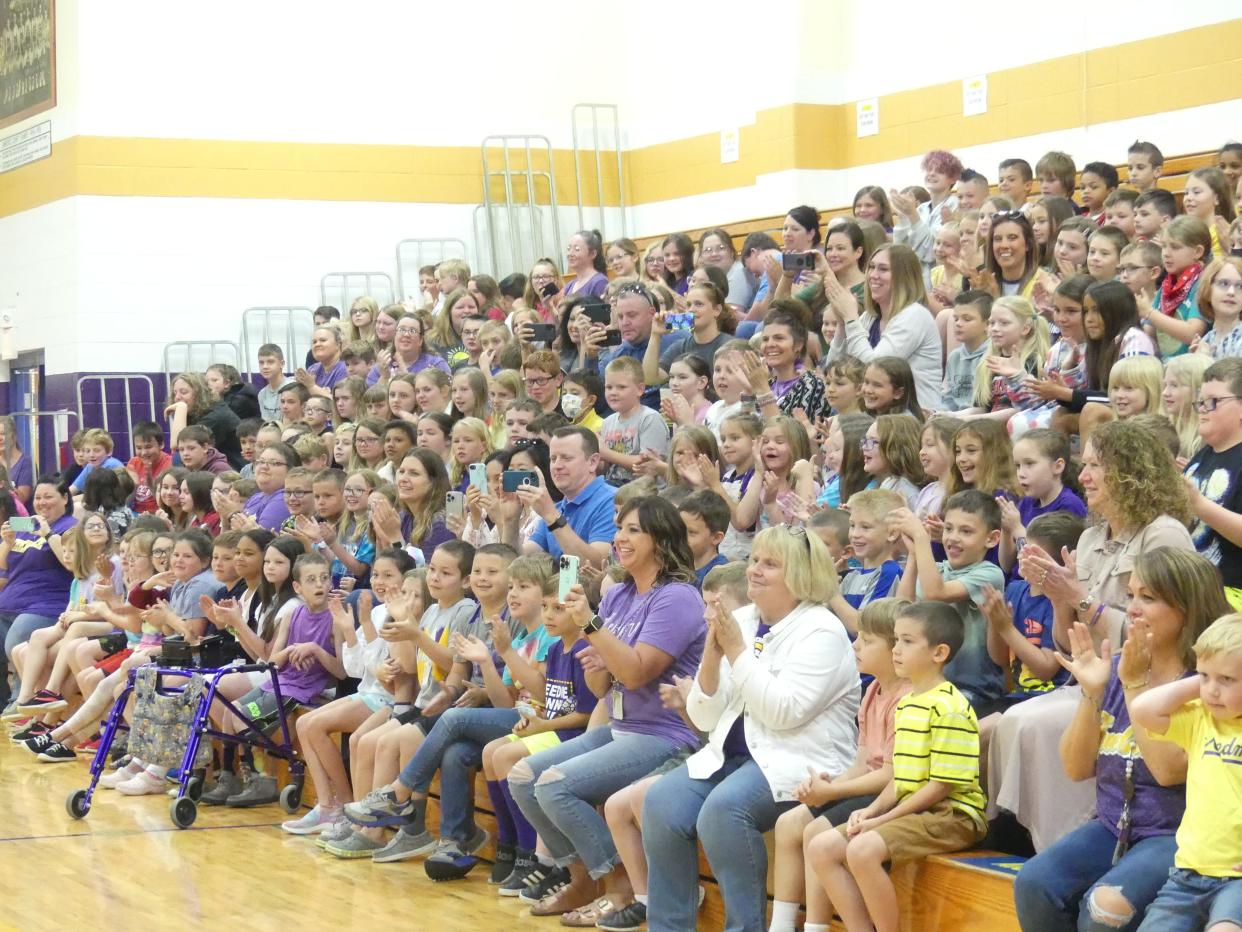 The audience cheers on the Needmore Robo-Toppers during Monday's surprise pep-rally for the team.